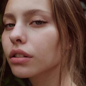 Close-up portrait of a young woman with natural beauty and striking expression.